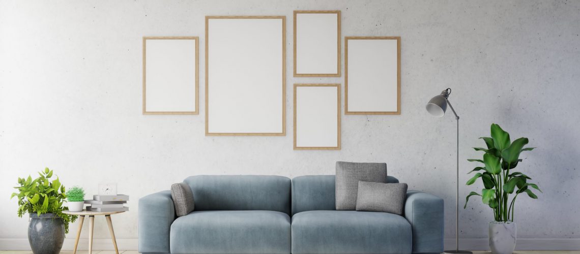 Poster mockup with vertical frames on empty white wall in living room interior ad dark blue sofa. 3D rendering.